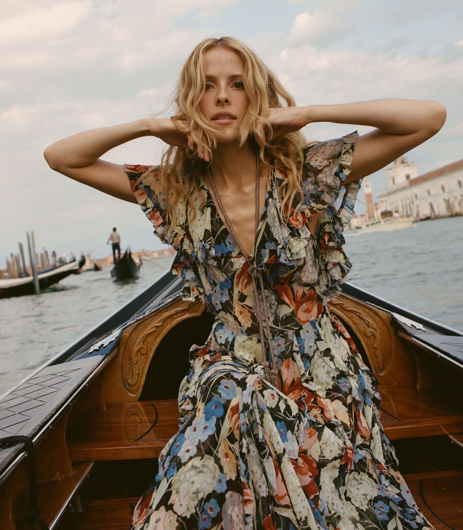 Woman in floral dress on a boat, enjoying a beautiful day near the water in a stylish Dresses.